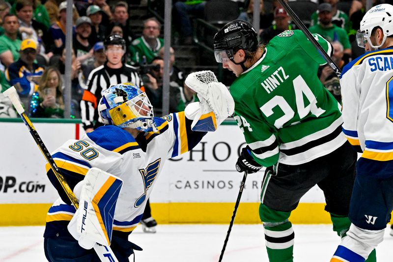 Apr 17, 2024; Dallas, Texas, USA; St. Louis Blues goaltender Jordan Binnington (50) makes a glove save in front of Dallas Stars center Roope Hintz (24) during the second period at the American Airlines Center. Mandatory Credit: Jerome Miron-USA TODAY Sports