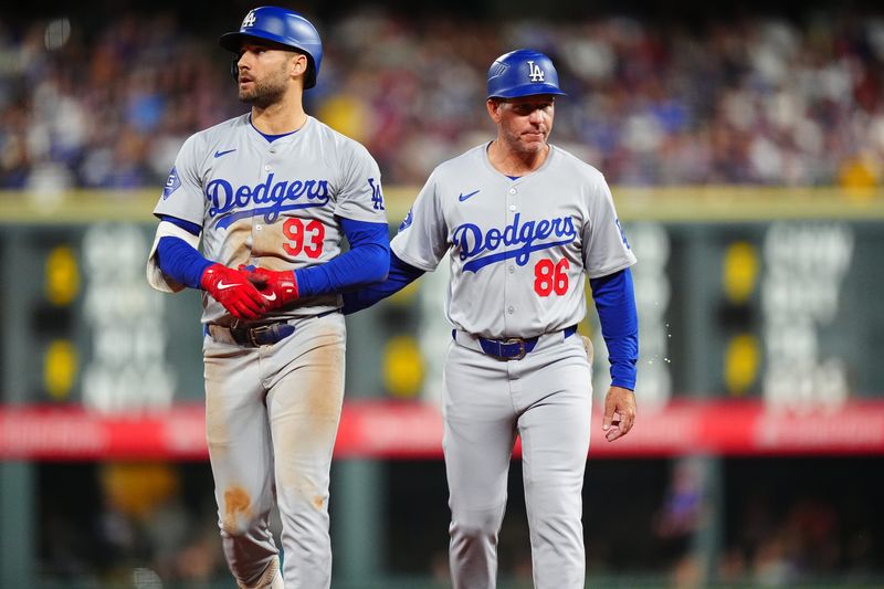 Sep 28, 2024; Denver, Colorado, USA; Los Angeles Dodgers center fielder Kevin Kiermaier (93) walks off with first base coach Clayton McCullough (86) following a injury in the fourth inning against the Colorado Rockies at Coors Field. Mandatory Credit: Ron Chenoy-Imagn Images