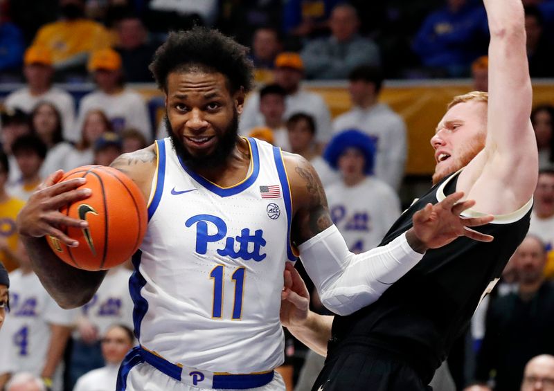 Jan 25, 2023; Pittsburgh, Pennsylvania, USA; Pittsburgh Panthers guard Jamarius Burton (11) drives to the basket against Wake Forest Demon Deacons guard Cameron Hildreth (right) during the first half at the Petersen Events Center. Mandatory Credit: Charles LeClaire-USA TODAY Sports