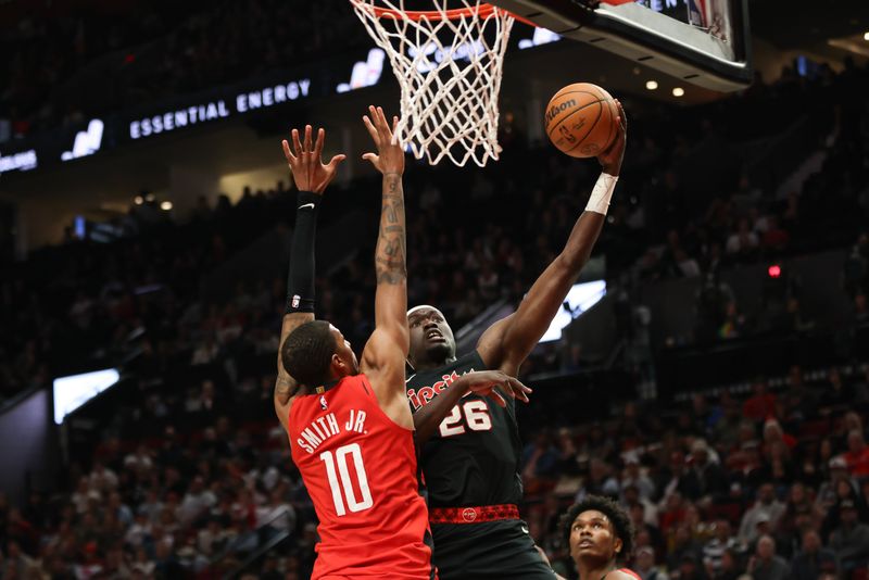 PORTLAND, OREGON - APRIL 12: Duop Reath #26 of the Portland Trail Blazers drives to the basket as Jabari Smith Jr. #10 of the Houston Rockets defends during the fourth quarter at Moda Center on April 12, 2024 in Portland, Oregon. NOTE TO USER: User expressly acknowledges and agrees that, by downloading and or using this photograph, User is consenting to the terms and conditions of the Getty Images License Agreement.? (Photo by Amanda Loman/Getty Images)