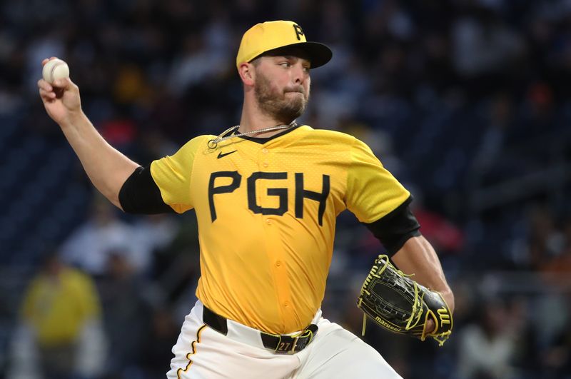 May 23, 2025; Pittsburgh, Pennsylvania, USA;  Pittsburgh Pirates relief pitcher Tanner Rainey (27) pitches against the Milwaukee Brewers during the seventh inning at PNC Park. Mandatory Credit: Charles LeClaire-Imagn Images