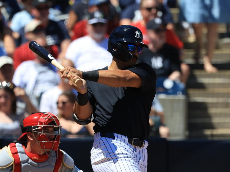 Mar 22, 2026; Tampa, Florida, USA; New York Yankees center fielder Trent Grisham (12) singles during the third inning against the Philadelphia Phillies  at George M. Steinbrenner Field. Mandatory Credit: Kim Klement Neitzel-Imagn Images