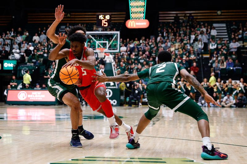 Mar 3, 2023; Fort Collins, Colorado, USA; New Mexico Lobos guard Jamal Mashburn Jr. (5) drives to the net against Colorado State Rams guard Jalen Lake (15) and guard Tavi Jackson (2) in the first half at Moby Arena. Mandatory Credit: Isaiah J. Downing-USA TODAY Sports