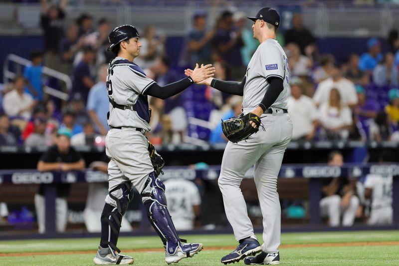 Aug 11, 2023; Miami, Florida, USA; New York Yankees relief pitcher Clay Holmes (35) celebrates with catcher Kyle Higashioka (66) after winning the game against the Miami Marlins at loanDepot Park. Mandatory Credit: Sam Navarro-USA TODAY Sports