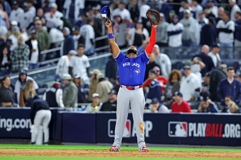 Oct 8, 2025; Bronx, New York, USA; Toronto Blue Jays first baseman Vladimir Guerrero Jr. (27) celebrates after beating the New York Yankees to win the ALDS round for the 2025 MLB playoffs at Yankee Stadium. Mandatory Credit: Brad Penner-Imagn Images