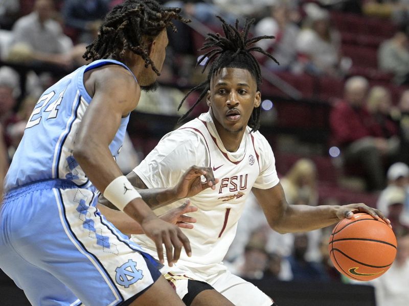 Feb 24, 2025; Tallahassee, Florida, USA;  Florida State Seminoles forward Jamir Watkins (1) is defended by North Carolina Tarheels Jae'Lyn Withers (24) during the first half at Donald L. Tucker Center. Mandatory Credit: Melina Myers-Imagn Images