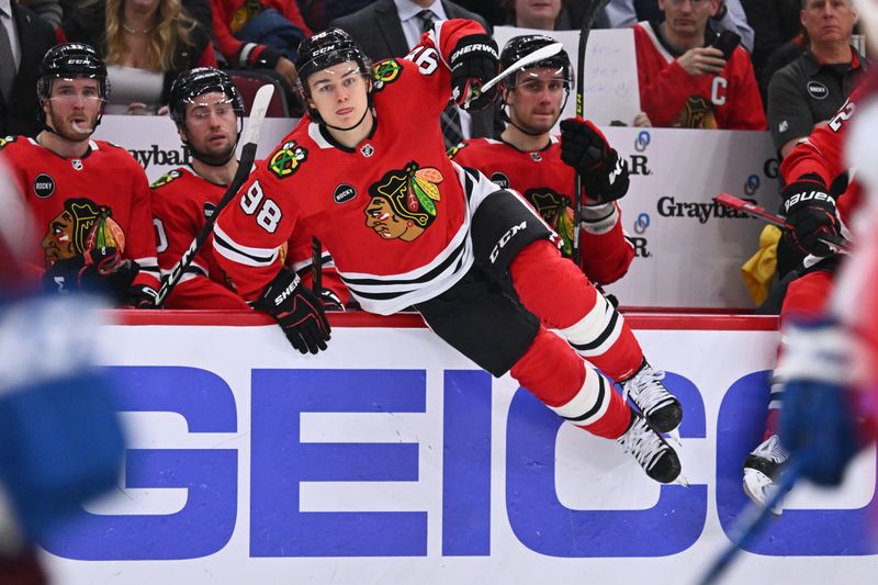 Dec 19, 2023; Chicago, Illinois, USA; Chicago Blackhawks forward Connor Bedard (98) hops over the boards to take a shift in the first period against the Colorado Avalanche at United Center. Mandatory Credit: Jamie Sabau-USA TODAY Sports