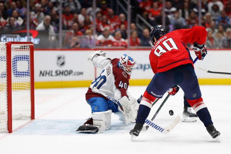 Nov 21, 2024; Washington, District of Columbia, USA; Colorado Avalanche goaltender Alexandar Georgiev (40) makes a save on Washington Capitals left wing Pierre-Luc Dubois (80) in the third period at Capital One Arena. Mandatory Credit: Geoff Burke-Imagn Images