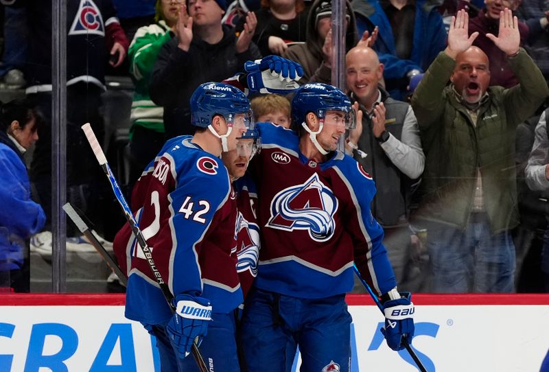 Dec 2, 2025; Denver, Colorado, USA;Colorado Avalanche center Brock Nelson (11) celebrates his goal with defenseman Devon Toews (7) and defenseman Josh Manson (42) in the second period against the Vancouver Canucks at Ball Arena. Mandatory Credit: Ron Chenoy-Imagn Images