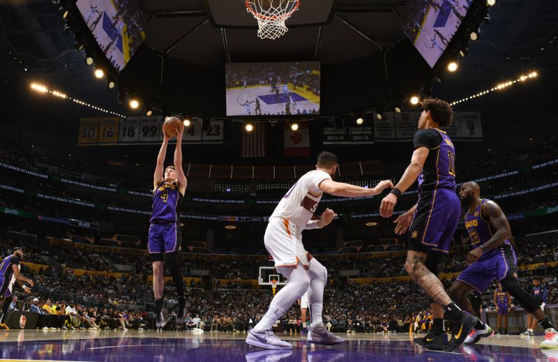 LOS ANGELES, CA - OCTOBER 25: Dalton Knecht #4 of the Los Angeles Lakers goes up for the rebound during the game against the Phoenix Suns on October 25, 2024 at Crypto.Com Arena in Los Angeles, California. NOTE TO USER: User expressly acknowledges and agrees that, by downloading and/or using this Photograph, user is consenting to the terms and conditions of the Getty Images License Agreement. Mandatory Copyright Notice: Copyright 2024 NBAE (Photo by Adam Pantozzi/NBAE via Getty Images)