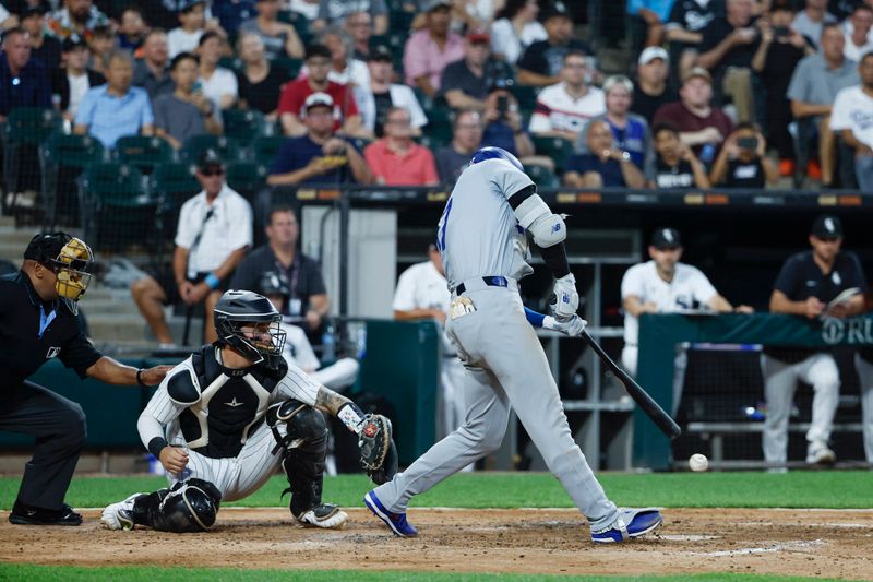 Jun 25, 2024; Chicago, Illinois, USA; Los Angeles Dodgers designated hitter Shohei Ohtani (17) hits an RBI-single against the Chicago White Sox during the fourth inning at Guaranteed Rate Field. Mandatory Credit: Kamil Krzaczynski-USA TODAY Sports