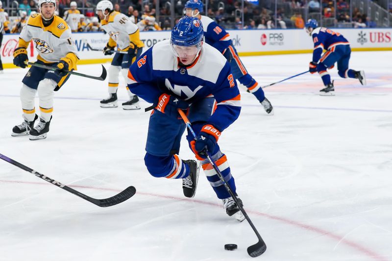 Apr 6, 2024; Elmont, New York, USA; New York Islanders defenseman Mike Reilly (2) skates the puck into the zone against the Nashville Predators during the second period at UBS Arena. Mandatory Credit: Tom Horak-USA TODAY Sports