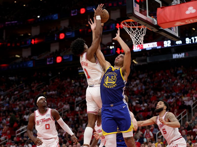 HOUSTON, TEXAS - APRIL 04: Amen Thompson #1 of the Houston Rockets battles Trayce Jackson-Davis #32 of the Golden State Warriors for a rebound in the second half at Toyota Center on April 04, 2024 in Houston, Texas.  NOTE TO USER: User expressly acknowledges and agrees that, by downloading and or using this photograph, User is consenting to the terms and conditions of the Getty Images License Agreement. (Photo by Tim Warner/Getty Images)