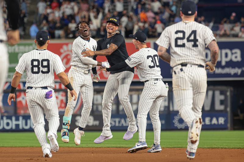 Sep 11, 2024; Bronx, New York, USA; New York Yankees third baseman Jazz Chisholm Jr. (13) celebrates with starting pitcher Luis Gil (81) and teammates after hitting a game winning RBI single during the eleventh inning against the Kansas City Royals at Yankee Stadium. Mandatory Credit: Vincent Carchietta-Imagn Images