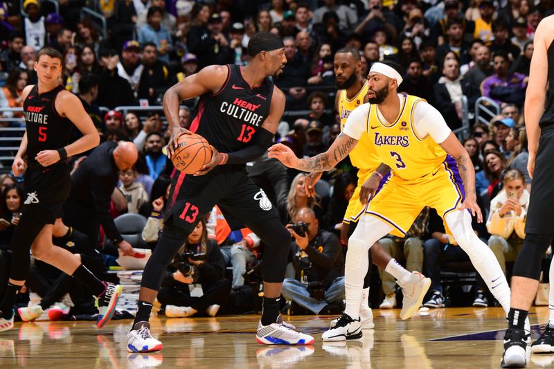 LOS ANGELES, CA - JANUARY 3: Bam Adebayo #13 of the Miami Heat handles the ball against defender Anthony Davis #3 of the Los Angeles Lakers during the game on January 3, 2024 at Crypto.Com Arena in Los Angeles, California. NOTE TO USER: User expressly acknowledges and agrees that, by downloading and/or using this Photograph, user is consenting to the terms and conditions of the Getty Images License Agreement. Mandatory Copyright Notice: Copyright 2024 NBAE (Photo by Adam Pantozzi/NBAE via Getty Images)