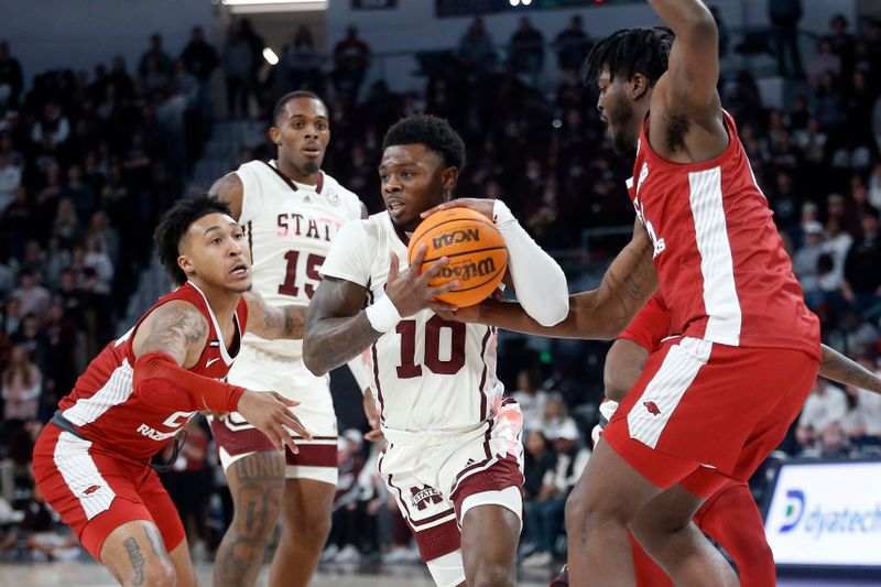 Feb 17, 2024; Starkville, Mississippi, USA; Mississippi State Bulldogs guard Dashawn Davis (10) drives to the basket between Arkansas Razorbacks guard Jeremiah Davenport (24) and forward Makhi Mitchell (15) during the first half at Humphrey Coliseum. Mandatory Credit: Petre Thomas-USA TODAY Sports