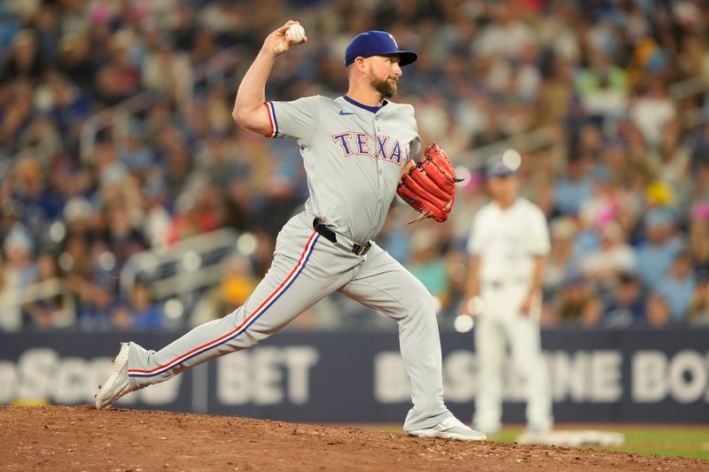 Jul 26, 2024; Toronto, Ontario, CAN; Texas Rangers pitcher Kirby Yates (39) pitches to the Toronto Blue Jays in the ninth inning at Rogers Centre. Mandatory Credit: John E. Sokolowski-USA TODAY Sports