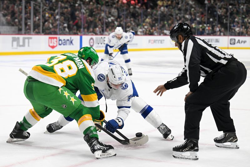 Mar 3, 2026; Saint Paul, Minnesota, USA;  Minnesota Wild forward Ryan Hartman (38) and Tampa Bay Lightning forward Anthony Cirelli (71) face-off during the first period at Grand Casino Arena. Mandatory Credit: Nick Wosika-Imagn Images