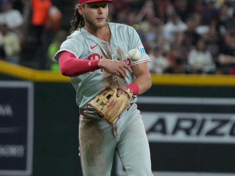 Aug 9, 2024; Phoenix, Arizona, USA; Philadelphia Phillies third base Alec Bohm (28) makes the off balance throw for an out against the Arizona Diamondbacks in the first inning at Chase Field. Mandatory Credit: Rick Scuteri-USA TODAY Sports