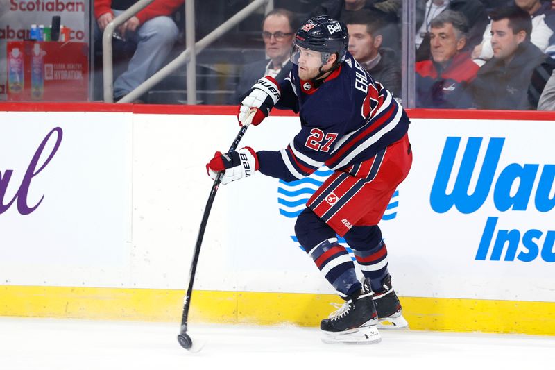 Dec 20, 2023; Winnipeg, Manitoba, CAN; Winnipeg Jets left wing Nikolaj Ehlers (27) fires the puck up the ice in the first period against the Detroit Red Wings at Canada Life Centre. Mandatory Credit: James Carey Lauder-USA TODAY Sports