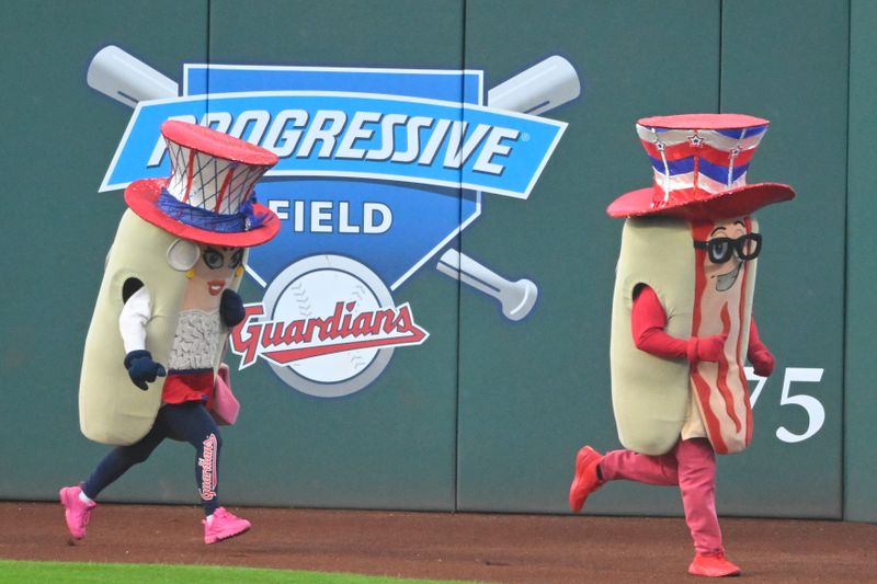 Jul 4, 2023; Cleveland, Ohio, USA; Hot dog mascots run during a game between the Cleveland Guardians and the Atlanta Braves at Progressive Field. Mandatory Credit: David Richard-USA TODAY Sports