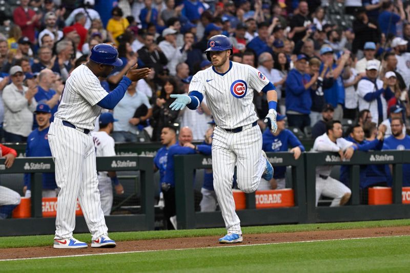 May 16, 2024; Chicago, Illinois, USA; Chicago Cubs outfielder Ian Happ (8) celebrates with third base coach Willie Harris (33) after hitting a home run against the Pittsburgh Pirates during the second inning at Wrigley Field. Mandatory Credit: Matt Marton-USA TODAY Sports