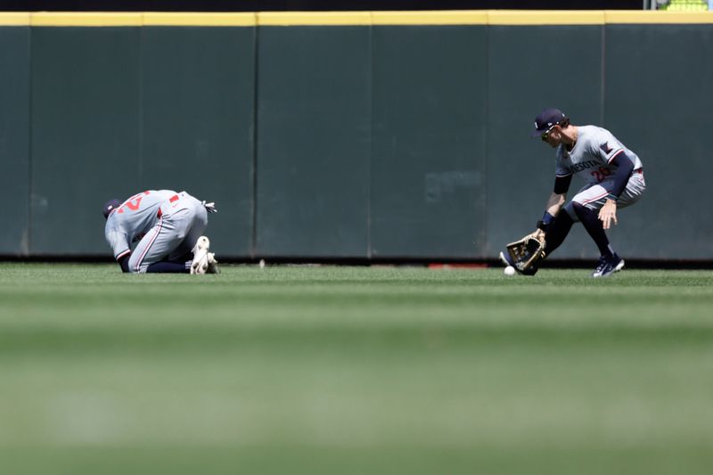 Jun 30, 2024; Seattle, Washington, USA; Minnesota Twins right fielder Max Kepler (26) reaches for the ball after Minnesota Twins center fielder Byron Buxton (25) misplayed it during the fifth inning against the Seattle Mariners at T-Mobile Park. Mandatory Credit: John Froschauer-USA TODAY Sports