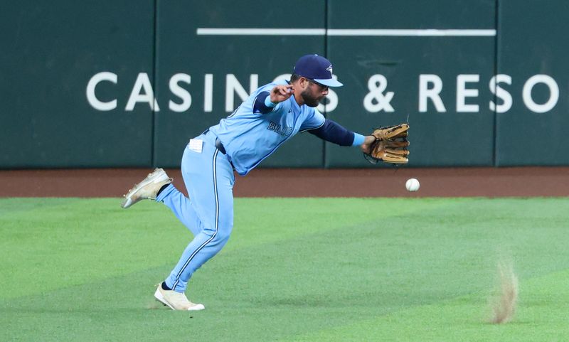 Sep 18, 2024; Arlington, Texas, USA;  Toronto Blue Jays left fielder Davis Schneider (36) cannot field a ball during the first inning against the Texas Rangers at Globe Life Field. Mandatory Credit: Kevin Jairaj-Imagn Images