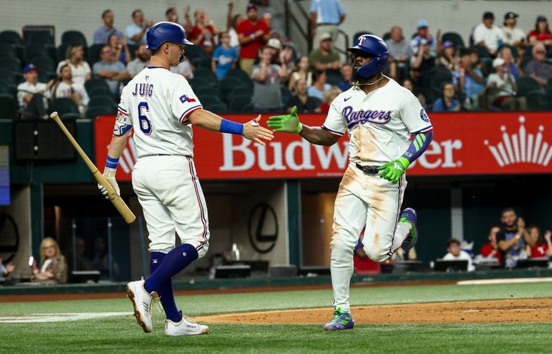 Aug 27, 2025; Arlington, Texas, USA;  Texas Rangers right fielder Adolis Garcia (53) celebrates with Texas Rangers third baseman Josh Jung (6) after scoring during the fourth inning against the Los Angeles Angels at Globe Life Field. Mandatory Credit: Kevin Jairaj-Imagn Images