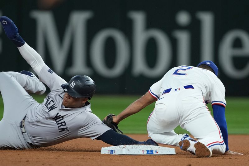 Sep 3, 2024; Arlington, Texas, USA; Texas Rangers second baseman Marcus Semien (2) tags out New York Yankees right fielder Juan Soto (22) while attempting to steal second base during the fifth inning at Globe Life Field. Mandatory Credit: Jim Cowsert-Imagn Images