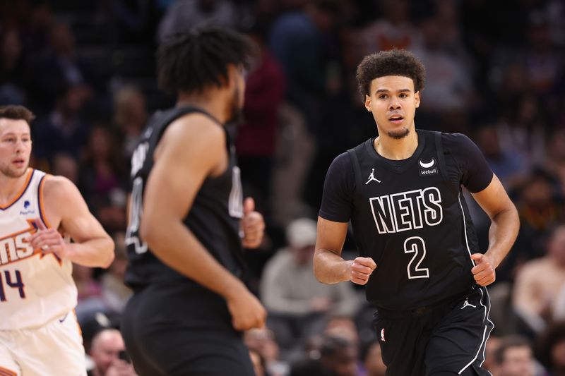 PHOENIX, ARIZONA - DECEMBER 13: Cameron Johnson #2 of the Brooklyn Nets reacts after a three-point shot against the Phoenix Suns during the first half of the NBA game at Footprint Center on December 13, 2023 in Phoenix, Arizona. NOTE TO USER: User expressly acknowledges and agrees that, by downloading and or using this photograph, User is consenting to the terms and conditions of the Getty Images License Agreement.  (Photo by Christian Petersen/Getty Images)