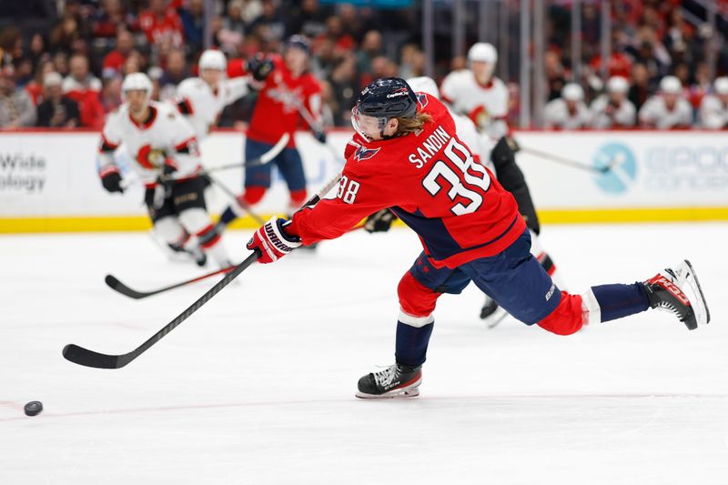 Feb 26, 2024; Washington, District of Columbia, USA; Washington Capitals defenseman Rasmus Sandin (38) shoots the puck against the Ottawa Senators in the third period at Capital One Arena. Mandatory Credit: Geoff Burke-USA TODAY Sports