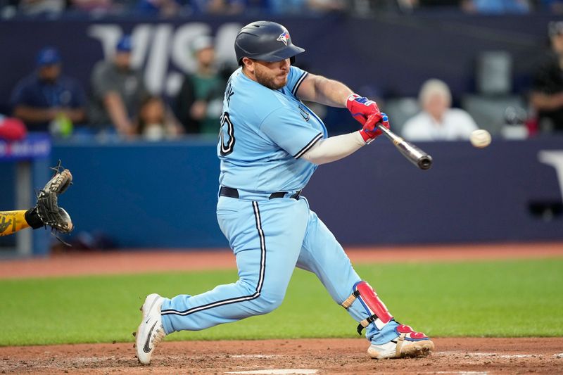 May 30, 2023; Toronto, Ontario, CAN; Toronto Blue Jays catcher Alejandro Kirk (30) hits a single against the Milwaukee Brewers during the fifth inning at Rogers Centre. Mandatory Credit: John E. Sokolowski-USA TODAY Sports