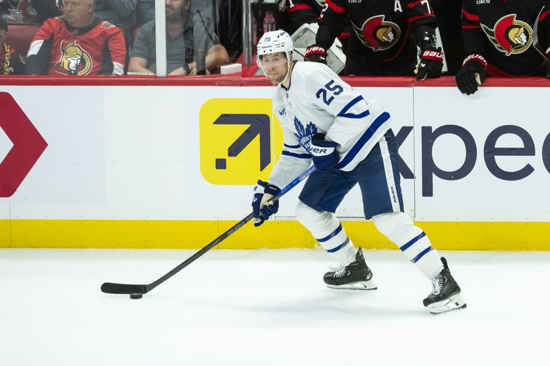 Apr 26, 2025; Ottawa, Ontario, CAN; Toronto Maple Leafs defenseman Brandon Carlo (25) controls the puck in game four of the first round of the 2025 Stanley Cup Playoffs against the Ottawa Senators at the Canadian Tire Centre. Mandatory Credit: Marc DesRosiers-Imagn Images