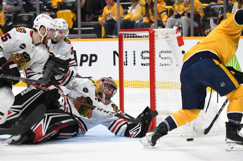 Jan 2, 2024; Nashville, Tennessee, USA; Chicago Blackhawks goaltender Arvid Soderblom (40) blocks a shot by Nashville Predators center Tommy Novak (82) during the third period at Bridgestone Arena. Mandatory Credit: Christopher Hanewinckel-USA TODAY Sports