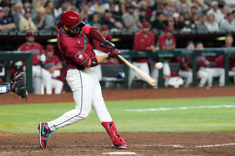 Apr 29, 2024; Phoenix, Arizona, USA; Arizona Diamondbacks third base Eugenio Suárez (28) hits an RBI single against the Los Angeles Dodgers during the fifth inning at Chase Field. Mandatory Credit: Joe Camporeale-USA TODAY Sports