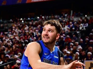 PHOENIX, AZ - DECEMBER 25: Luka Doncic #77 of the Dallas Mavericks looks on during the game against the Phoenix Suns on December 25, 2023 at Footprint Center in Phoenix, Arizona. NOTE TO USER: User expressly acknowledges and agrees that, by downloading and or using this photograph, user is consenting to the terms and conditions of the Getty Images License Agreement. Mandatory Copyright Notice: Copyright 2023 NBAE (Photo by Barry Gossage/NBAE via Getty Images)