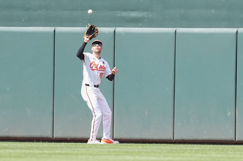 May 26, 2025; Baltimore, Maryland, USA; Baltimore Orioles center fielder Dylan Carlson (15) catches a fly ball hit by St. Louis Cardinals left fielder Lars Nootbaar (21) (not pictured) during the third inning at Oriole Park at Camden Yards. Mandatory Credit: Gregory Fisher-Imagn Images