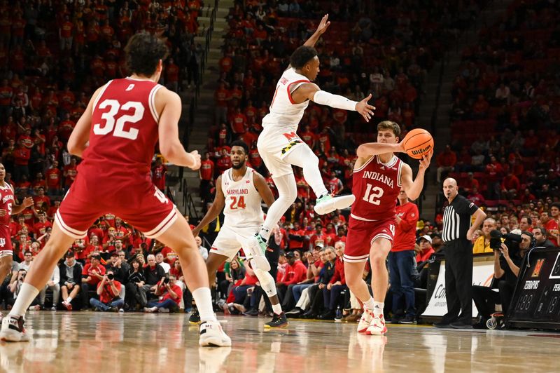 Jan 31, 2023; College Park, Maryland, USA;  Indiana Hoosiers forward Miller Kopp (12) passes as Maryland Terrapins guard Jahmir Young (1) leaps to defend during the second half at Xfinity Center. Mandatory Credit: Tommy Gilligan-USA TODAY Sports