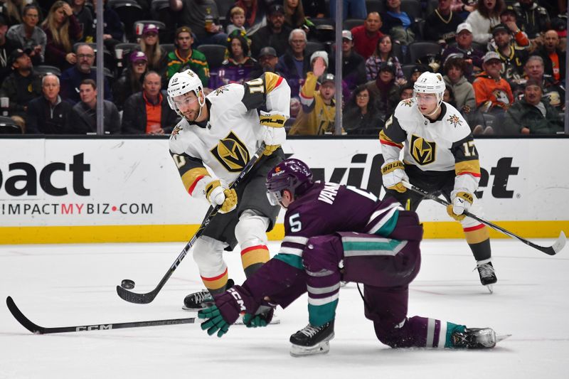 Dec 27, 2023; Anaheim, California, USA; Vegas Golden Knights center Nicolas Roy (10) passes the puck against the defense of Anaheim Ducks defenseman Urho Vaakanainen (5) during the second period at Honda Center. Mandatory Credit: Gary A. Vasquez-USA TODAY Sports