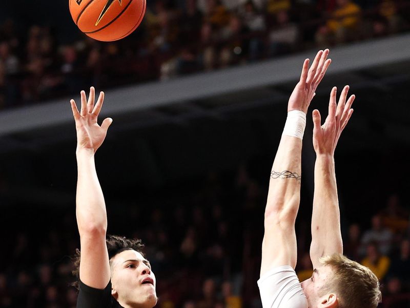 Feb 6, 2024; Minneapolis, Minnesota, USA; Minnesota Golden Gophers guard Mike Mitchell Jr. (2) shoots as Michigan State Spartans center Carson Cooper (15) defends during the first half at Williams Arena. Mandatory Credit: Matt Krohn-USA TODAY Sports