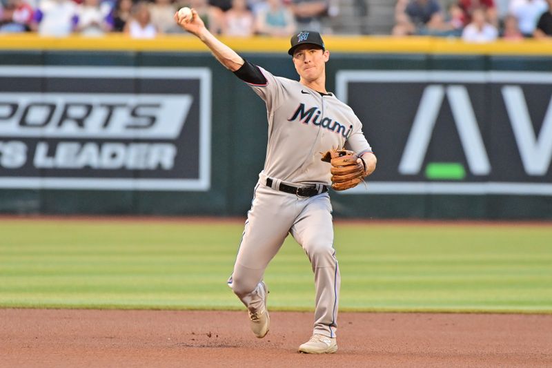 May 8, 2023; Phoenix, Arizona, USA;  Miami Marlins shortstop Joey Wendle (18) throws to first base in the first inning against the Arizona Diamondbacks at Chase Field. Mandatory Credit: Matt Kartozian-USA TODAY Sports