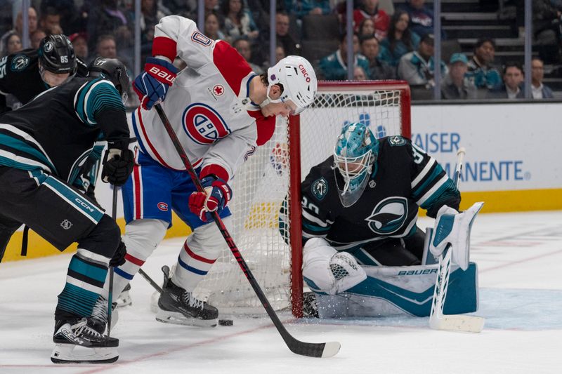 Mar 3, 2026; San Jose, California, USA;  San Jose Sharks goaltender Yaroslav Askarov (30) watches the puck during the third period against Montreal Canadiens left wing Juraj Slafkovský (20) at SAP Center at San Jose. Mandatory Credit: Stan Szeto-Imagn Images