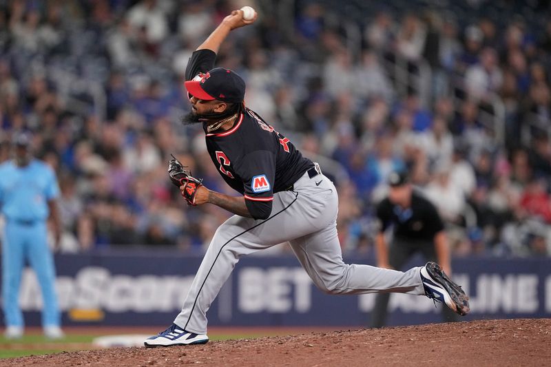 May 4, 2025; Toronto, Ontario, CAN; Cleveland Guardians pitcher Emmanuel Clase (48) pitches to the Toronto Blue Jays during the ninth inning at Rogers Centre. Mandatory Credit: John E. Sokolowski-Imagn Images
