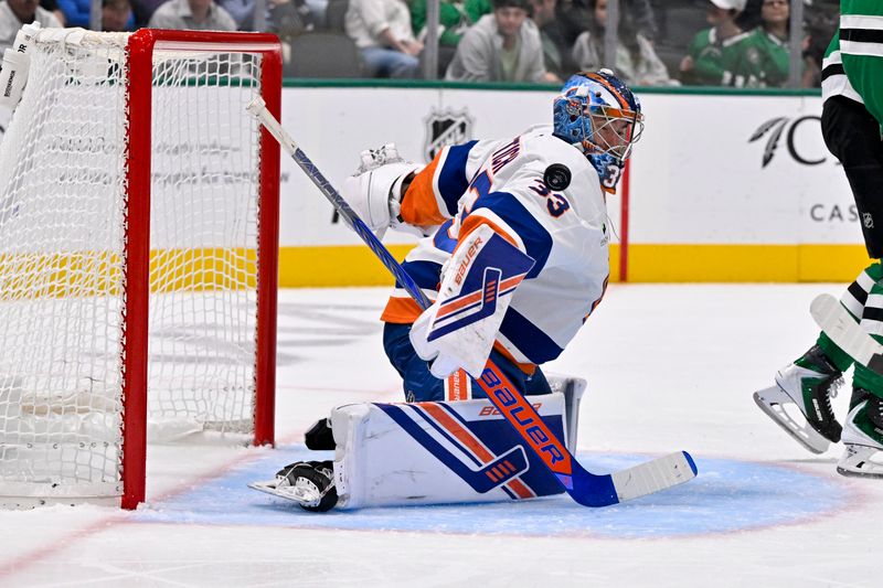 Nov 18, 2025; Dallas, Texas, USA; New York Islanders goaltender David Rittich (33) turns aside a Dallas Stars shot during the second period at the American Airlines Center. Mandatory Credit: Jerome Miron-Imagn Images