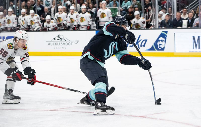 Jan 24, 2024; Seattle, Washington, USA; Seattle Kraken forward Tomas Tatar (90) scores a goal ahead of Chicago Blackhawks defenseman Kevin Korchinski (55) during the third period at Climate Pledge Arena. Mandatory Credit: Stephen Brashear-USA TODAY Sports