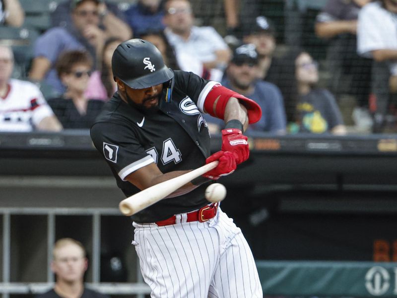 Aug 26, 2023; Chicago, Illinois, USA; Chicago White Sox designated hitter Eloy Jimenez (74) hits an RBI-single against the Oakland Athletics during the first inning at Guaranteed Rate Field. Mandatory Credit: Kamil Krzaczynski-USA TODAY Sports