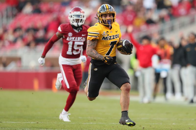 Nov 24, 2023; Fayetteville, Arkansas, USA; Missouri Tigers running back Cody Schrader (7) rushes against the Arkansas Razorbacks during the second quarter at Donald W. Reynolds Razorback Stadium. Mandatory Credit: Nelson Chenault-USA TODAY Sports