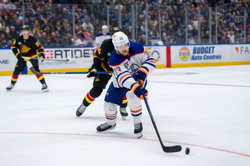 Nov 9, 2024; Vancouver, British Columbia, CAN; Edmonton Oilers forward Viktor Arvidsson (33) handles the puck against the Vancouver Canucks during the third period at Rogers Arena. Mandatory Credit: Bob Frid-Imagn Images