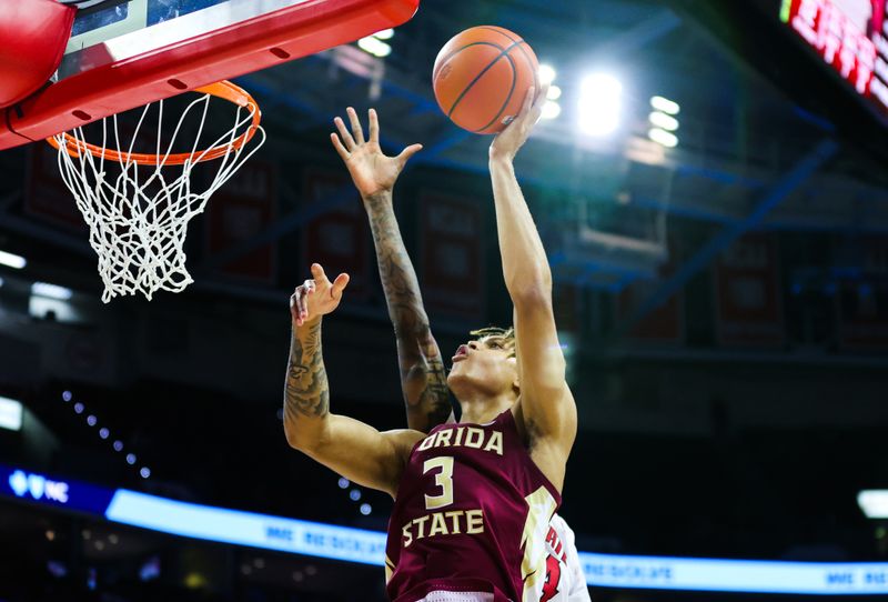 Feb 1, 2023; Raleigh, North Carolina, USA; Florida State Seminoles forward Cam Corhen (3) drives to the basket during the second half against the North Carolina State Wolfpack at PNC Arena.  Mandatory Credit: Jaylynn Nash-USA TODAY Sports